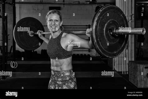 A Beautiful Middle Aged Blonde Woman With Sixpack Is Doing Back Squats