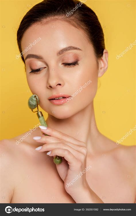 Beautiful Naked Woman Using Jade Roller Face Isolated Yellow Stock