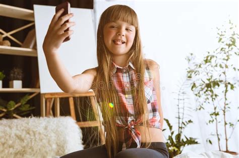 Little Girl Using Different Gadgets At Home Stock Photo Image Of