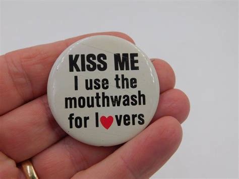 A Hand Holding A Button That Says Kiss Me I Use The Mouthwash For Love