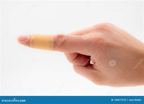 A Hand With A Patch On The Forefinger Isolated Against A White