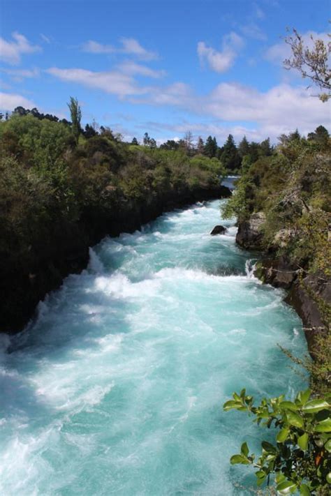 The Water Is Very Blue And Green In This Photo It Looks To Be Rushing