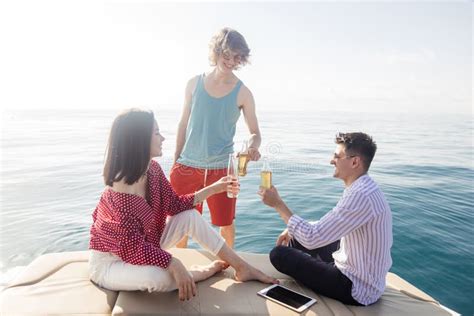 Yacht Drinking Beers While Talking Group Of Friends Having Party On