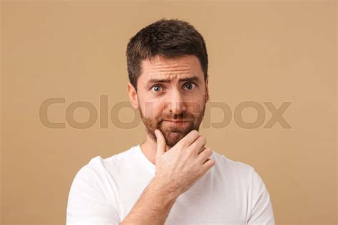 Portrait Of A Confused Young Man Casually Dressed Stock Image Colourbox