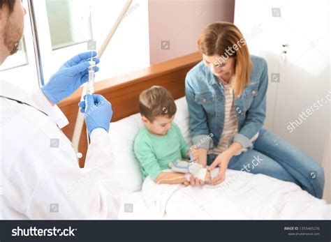 Doctor Adjusting Intravenous Drip Little Child Stock Photo 1355465276