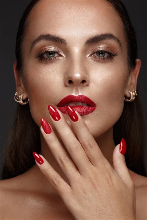 Beautiful Girl With A Classic Make Up And Red Nails Manicure Design