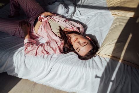 Brunette Woman In Pink Pajamas Lying On Bed Stock Image Image Of