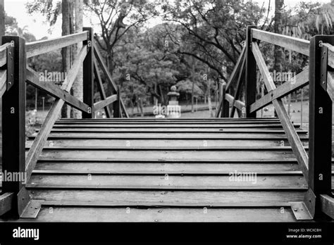 Wooden Footbridge With Trees In Background Stock Photo Alamy