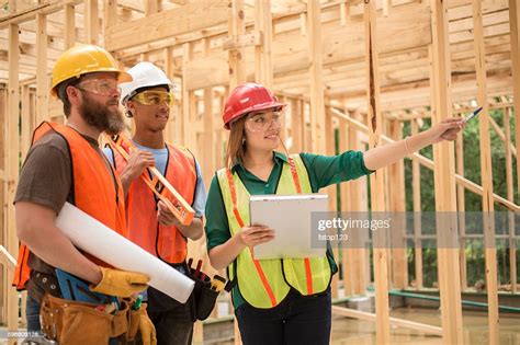 Workers At Construction Job Site Inside Framed Building High Res Stock