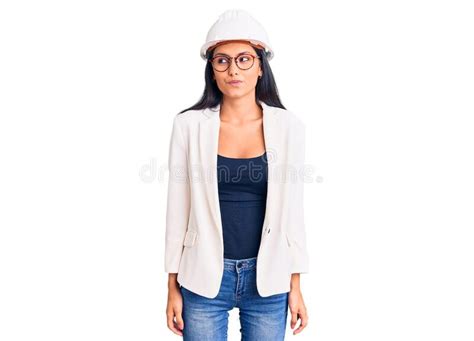 Young Beautiful Latin Girl Wearing Architect Hardhat And Glasses
