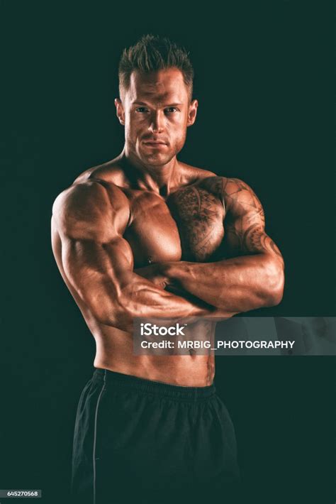 Handsome Muscular Men Flexing Muscles Stock Photo Download Image Now