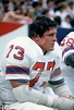 John Hannah #73 of the New England Patriots looks on from the bench ...