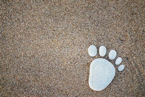 Nice Stone Made Footprint On The Sand Shore Background Stock Image
