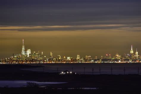 Brilliant Nyc Skyline At Night With Sandy Hook In Foreground Newjersey