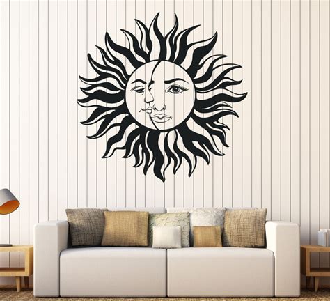 A Living Room With A White Couch And A Sun Wall Decal
