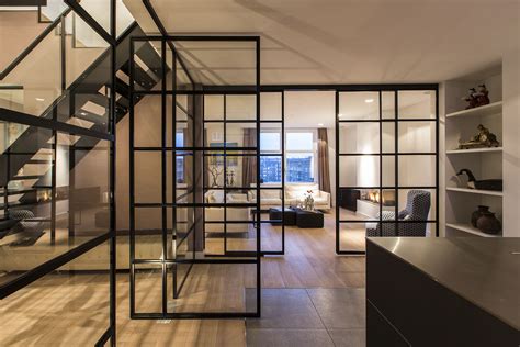 Black Framed Glass Doors Are A Prominent Feature Of This Apartments
