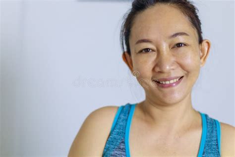 portrait of beautiful adult 40 years old asian woman in polka dots dress with arms crossed and
