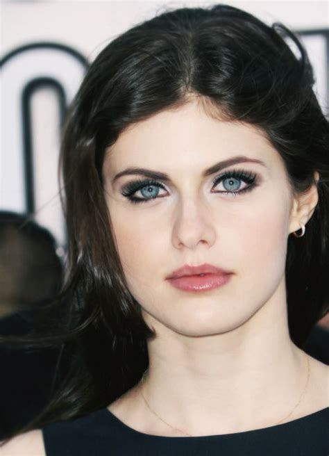 A Close Up Of A Person With Blue Eyes And Long Hair Wearing A Black Dress