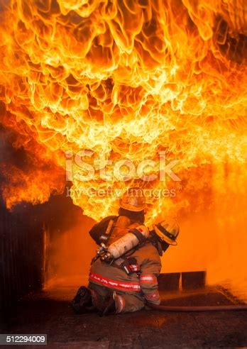 Learn fight fire with fire faster with songsterr plus plan! Firefighters Fighting Fire During Training Stock Photo ...
