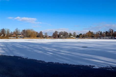 Snow Covered Frozen Lake Landscape In Northern Europe On A Sunny Day
