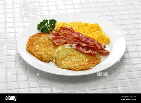 Diner Style Hash Browns Scrambled Eggs And Bacon Stock Photo Alamy