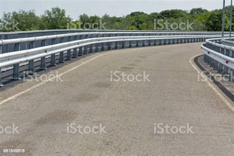 Modern Asphalt Road With Metal Fences And Walkway Closeup Stock Photo