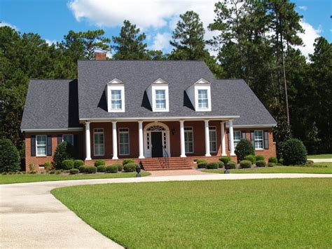 Quaint Two Story Brick Home With 6 Columns Capped With Three Dormers