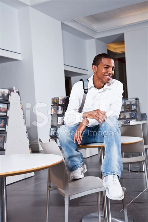 Young Man Hanging Out In Library Or Bookstore Stock Photo Royalty