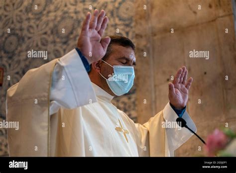 Catholic Priest Wearing A Face Mask While Celebrating Mass During The