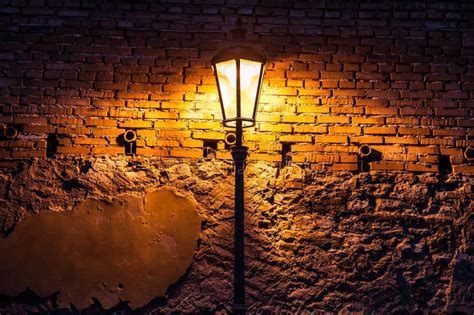 Vintage Street Lamp Against A Brick Wall At Night Stock Photo Image