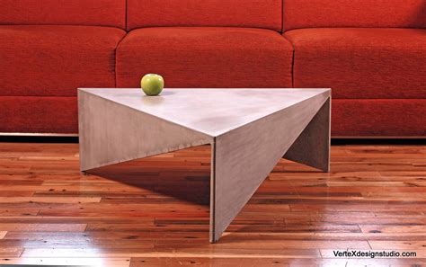 Normally coffee tables are round. Concrete Triangle Coffee Table
