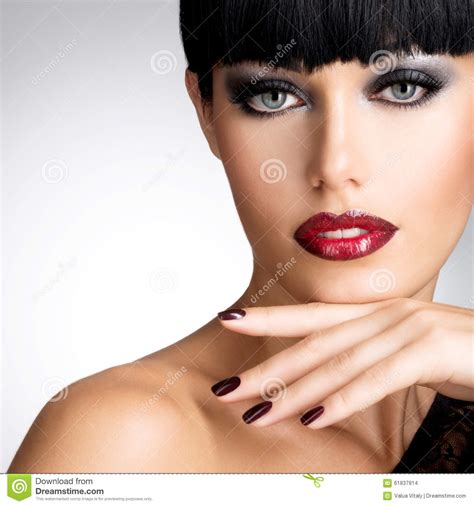 Face Of A Woman With Beautiful Dark Nails And Red Lips