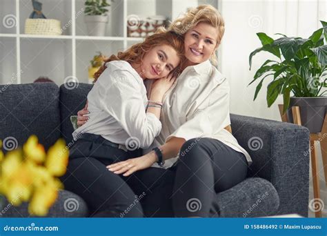 Happy Mother And Daughter Hugging On Sofa Stock Photo Image Of Sofa