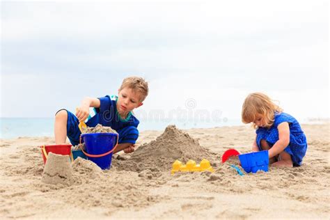 Kids Play With Sand On Summer Beach Stock Photo Image Of Care