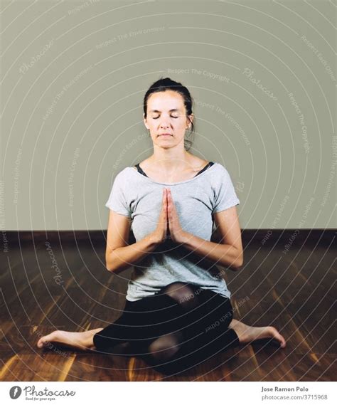 Woman Sitting Cross Legged On The Floor Doing Yoga Relaxation Exercises Concept Of Healthy