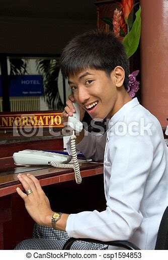 Asian smiling hotel receptionist. Asian smiling and ...