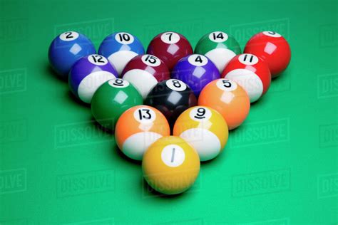 To rack the balls for a game of pool you need to get all the balls in the correct position, packed tight and positioned correctly over the dot. Pool balls racked and ready to break - Stock Photo - Dissolve