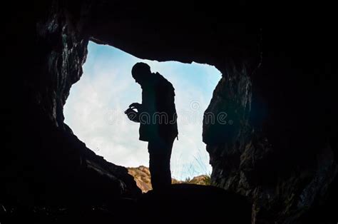 Cave Entrance With Silhouette Of Man Standing Stock Image Image Of