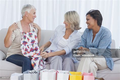 Mature Friends Admiring Purchases After Shopping Trip High Res Stock