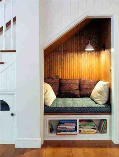 An Open Space Under The Stairs Is Filled With Books And Magazines As