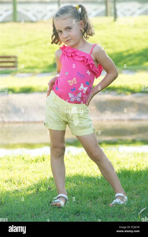 Small Girl Posing As A Model In A Garden Stock Photo Alamy