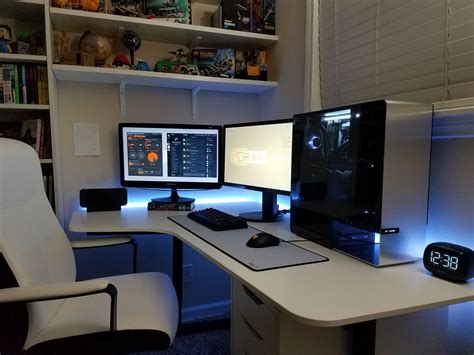 Two Computer Monitors Sitting On Top Of A Desk
