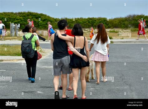 A Couple With Arms Wrapped Around Each Other Walking To The Beach Stock Photo Alamy