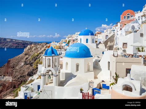 Greek Church With Three Blue Domes In The Village Of Oia Santorini