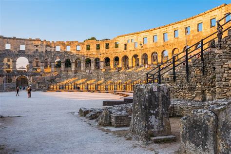 Architectural Details Of Pula Coliseum With Tourists In Croatia Stock