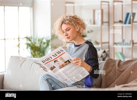 Beautiful Young Woman Reading Newspaper At Home Stock Photo Alamy