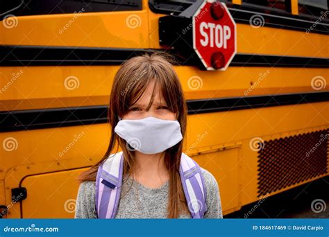 Coronavirus Reopening School Young Girl Wearing Facemask And Standing