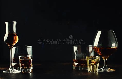 set of strong alcoholic drinks in glasses and shot glass in assortent vodka rum cognac