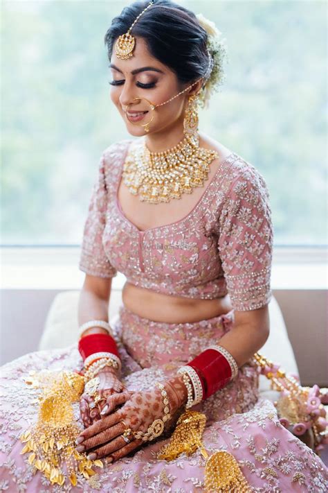 Photo Of Bride Wearing A Pastel Pink Lehenga With A Choker Necklace