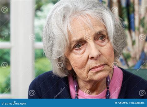 Head And Shoulders Portrait Of Thoughtful Senior Woman At Home Stock